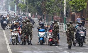 Army personnel check IDs at a checkpoint in Kathmandu after troops were deployed to restore order following youth-led anti-corruption protests that forced the Prime Minister's resignation.