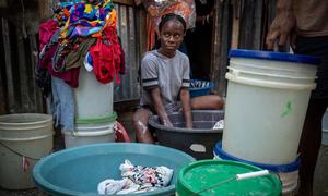 A woman washes clothes at a site for displaced people in Port-au-Prince, Haiti.