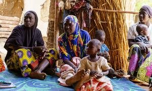Women and children sit in a shelter in March 2024 at a site in Soucoura, Mali, hosting refugees from Burkina Faso who fled violence.