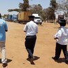 Maxwell Matewere (left), a crime prevention expert with the UN Office for Drugs and Crime (UNODC), is accompanied by two officials as he investigates human trafficking allegations in Malawi.