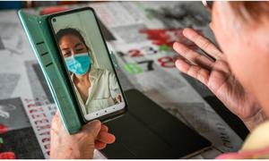 A woman in Singapore connects to the SingHealth Community Hospitals’ eSocial Prescribing programme at home with a digital device.