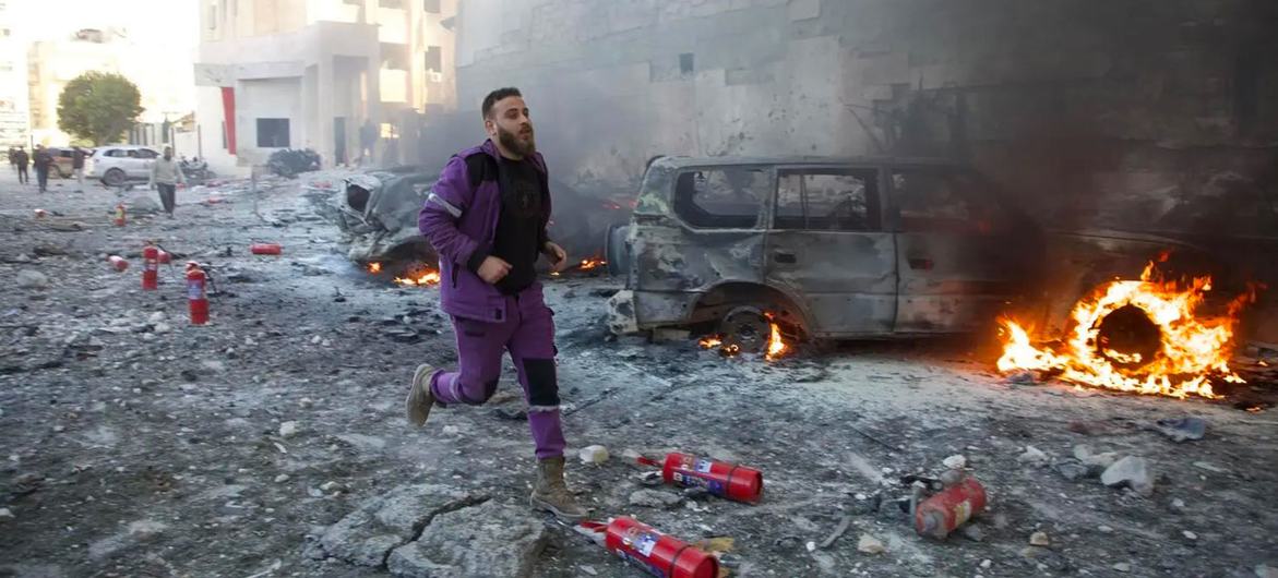 A first responder rushes through the aftermath of shelling that targeted hospitals and displaced camps in Idlib, northwest Syria (file).
