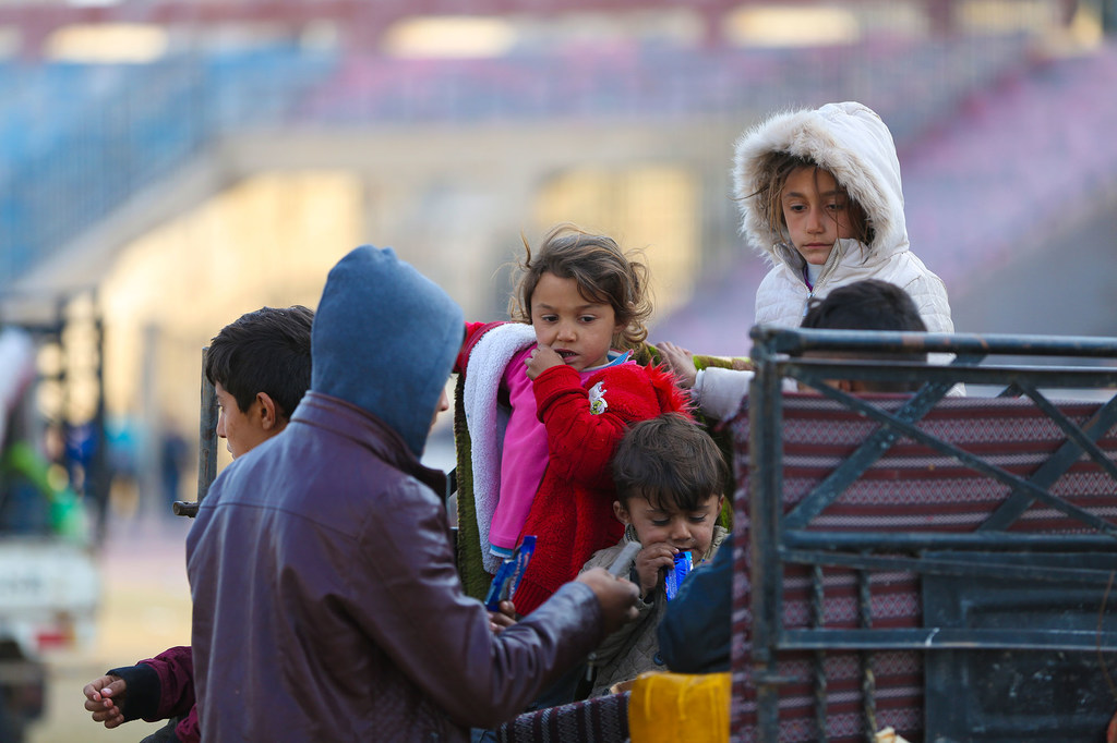 Niños vestidos con ropa de invierno se reúnen en un centro de acogida en Ar-Raqqa, Siria, el 4 de diciembre de 2024, tras huir de la violencia en Alepo.