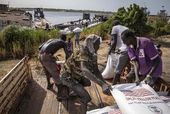 Sacks of split peas are transported to Jonglei State via the White Nile River in South Sudan.
