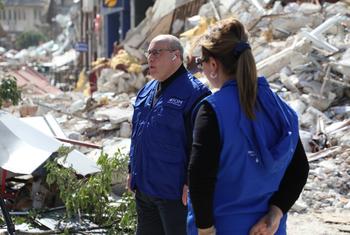IOM Director General Antonio Vitorino stands among the destruction in Antakya city caused by recent earthquakes.