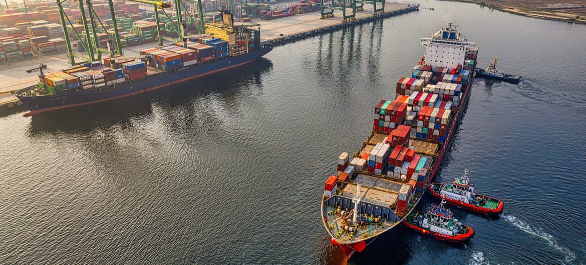 A cargo ship arrives at a port.