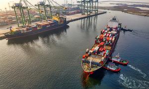 A cargo ship arrives at a port.