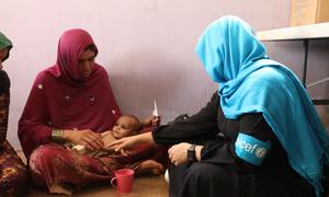 A health worker visits a family in the Afghan capital, Kabul.