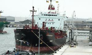 A cargo ship docked at a port in Europe.