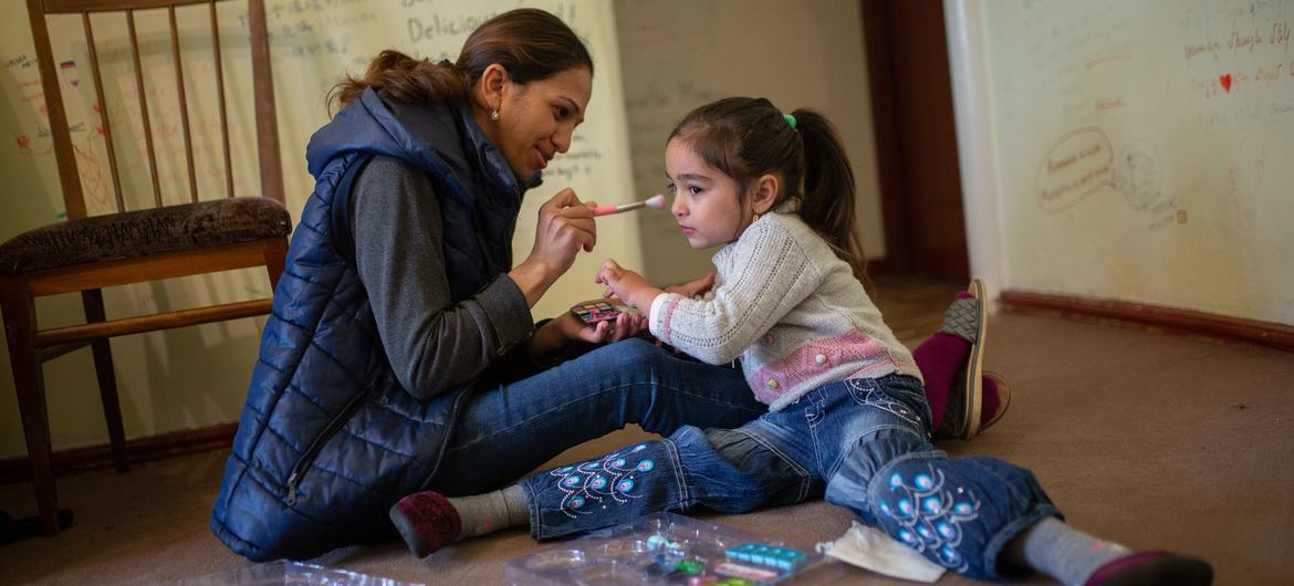 Una madre juega con su hija en su casa de Armenia.