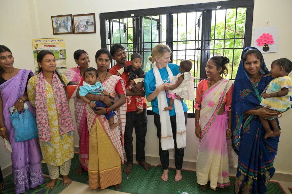 UNICEF की प्रतिनिधि सिंथिया मैककैफ्री और क्षेत्रीय सलाहकार सामंथा मोर्ट भारत के डिब्रूगढ़ में एक आंगनवाड़ी केंद्र में माताओं और उनके बच्चों के साथ खड़ी हैं।