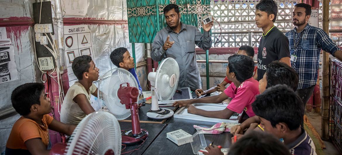 Young men from the Rohingya community receive electrician training at a refugee camp in southern Bangladesh. Young men from the Rohingya community receive electrician training at a refugee camp in southern Bangladesh.