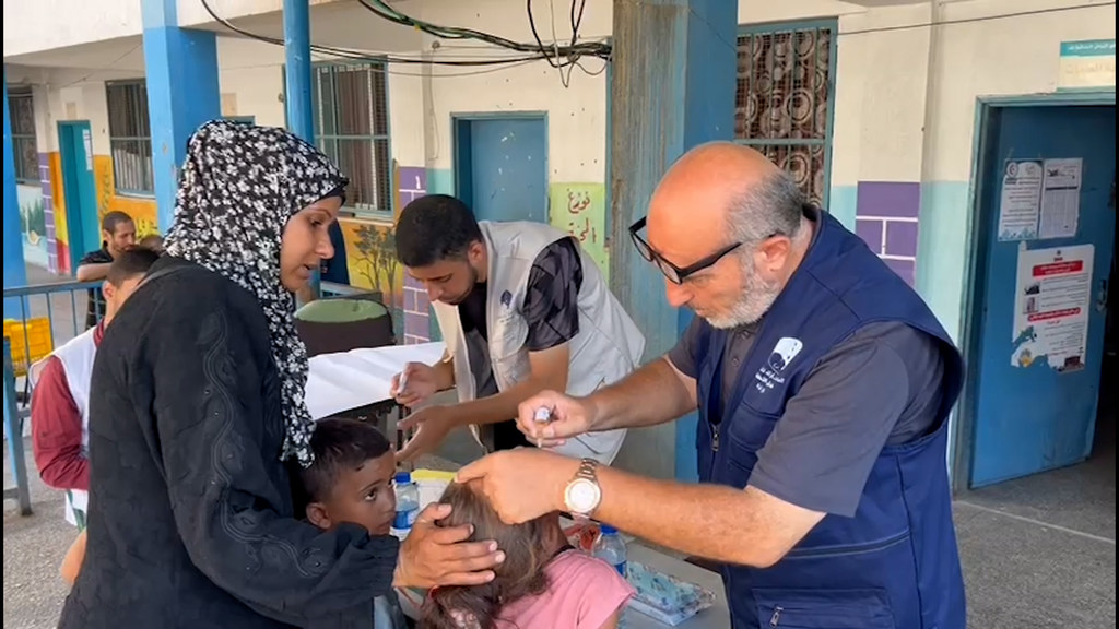 Om Samir, a mother, from Gaza City, with her children in an UNRWA school where the polio vaccination campaign is being conducted.