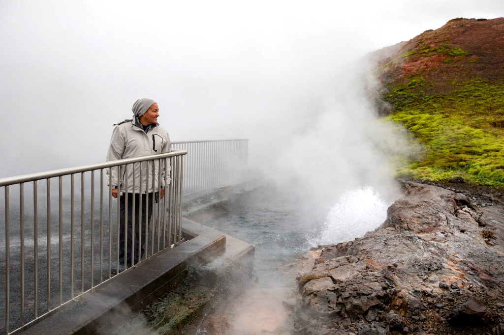 Deputy Secretary-General Amina Mohammed stands on a viewing platform next to the steaming Deildartunguhver hot spring in Iceland.