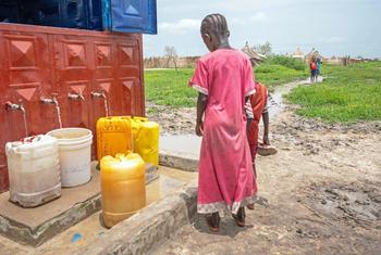 A girl collects water from a communal tap in the town of Renk, South Sudan. Since April 2023, over 810,000 people have crossed into the country from Sudan, many among them children.