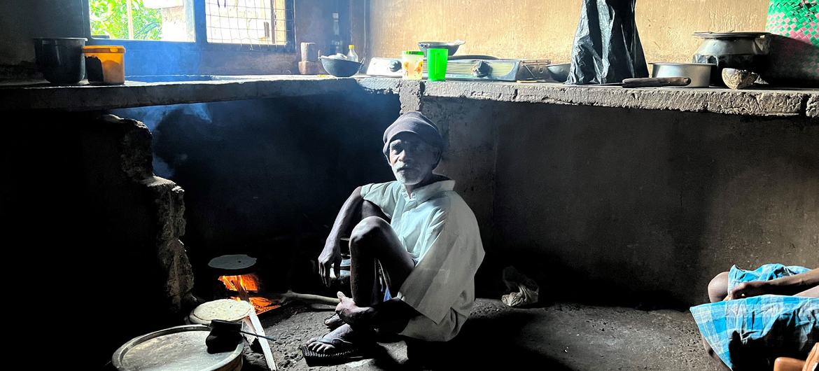 Tea estate worker Haidrooze cooks small wheat pancakes on a stove in the kitchen of his cottage in Ramboda, Sri Lanka.