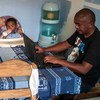 A father takes care of his young child while working from home in Madagascar.