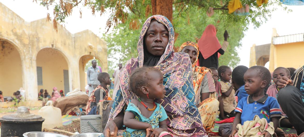 Mariam Djimé Adam, 33, is sitting in the yard of Adre's secondary school in Chad. She arrived from Sudan with her 8 children. 