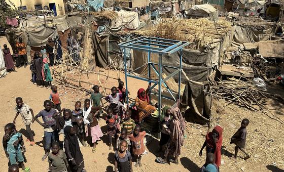 An aerial view of children and their families standing near temporary shelters at the Khamsa Dagiga site for displaced people in Zelingei Town, Central Darfur, Sudan. (file)