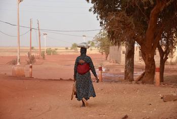 A woman walks through the town of Mopti in Mali. 