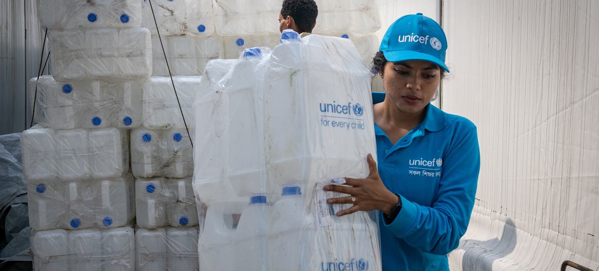 Staff prepare jerry cans for distribution at the UNICEF warehouse in Cox's Bazar ahead of Cyclone Mocha, which is expected to make landfall on 14 May.
