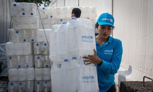 Staff prepare jerry cans for distribution at the UNICEF warehouse in Cox's Bazar ahead of Cyclone Mocha, which is expected to make landfall on 14 May.