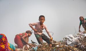 A ten-year-old boy works under hazardous and unhealthy conditions at a garbage dumping site in Dhaka, Bangladesh. (file)