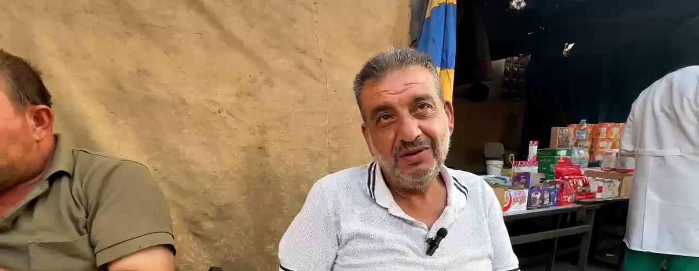 Ahmed Nassar, a Palestinian man, sits during an aid distribution in Deir Al-Balah, Gaza Strip.