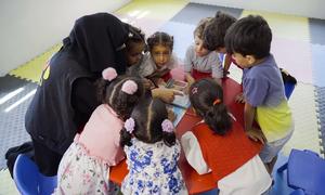 Children play with locally made educational toys in Yemen.