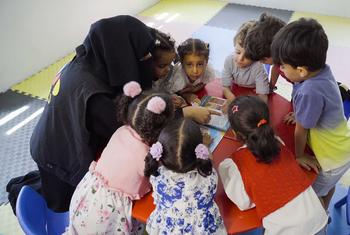 Children play with locally made educational toys in Yemen.