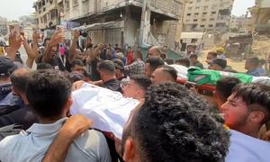 Mourners carry the body of a journalist killed in an Israeli airstrike on Gaza on August 10, 2025.