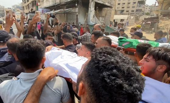 Mourners carry the body of a journalist killed in an Israeli airstrike on Gaza on August 10, 2025.