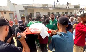 Mourners carry the body of a journalist killed in an Israeli airstrike on Gaza on August 10, 2025.