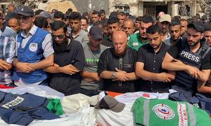 Mourners perform the funeral prayer for Palestinian journalists killed in an Israeli airstrike on August 10.
