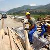 Homens trabalham na construção de uma nova estrada na Albânia