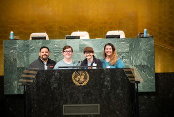 Make a Wish recipient tours the UN with his family. Here at the Podium of the General Assembly