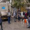 Des familles remplissent des jerrycans d'eau potable à un point de distribution dans le quartier d'Almyassar, dans la ville d'Alep, dans le nord de la Syrie.