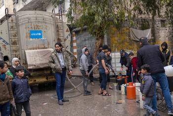 Families fill jerrycans with clean water at a distribution point in Almyassar neighbourhood, Aleppo city, in northern Syria.