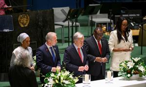 Secretary-General António Guterres (centre) and other participants light candles at the UN General Assembly event commemorating the International Day of Reflection on the 1994 Genocide against the Tutsi in Rwanda.