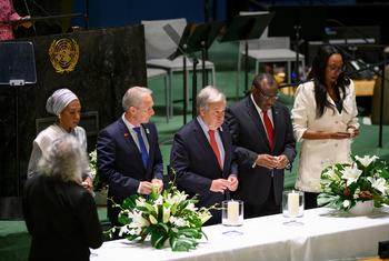 Secretary-General António Guterres (centre) and other participants light candles at the UN General Assembly event commemorating the International Day of Reflection on the 1994 Genocide against the Tutsi in Rwanda.
