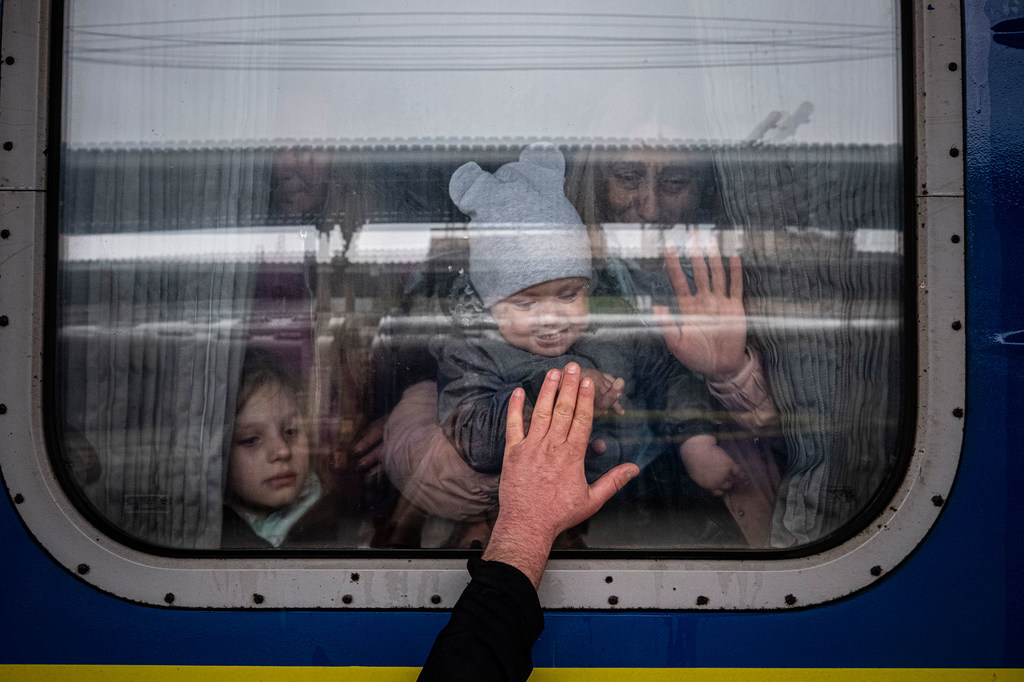 在乌克兰哈尔科夫，一名男子把手放在火车车厢的窗户上。 