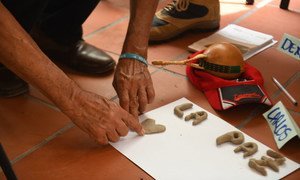 A participant in a reconciliation programme in Colombia spells out the word 'peace', in Spanish.