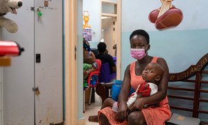 A two-year-old girl and her mother wait to see a doctor at a pediatric oncology unit in Ghana.