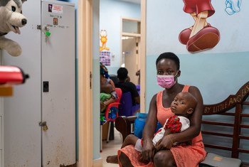 A two-year-old girl and her mother wait to see a doctor at a pediatric oncology unit in Ghana.