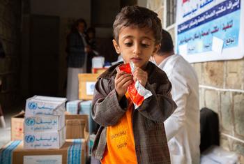 A young malnourished boy in Yemen eats the Ready-to-Use Therapeutic Food (RUTF).