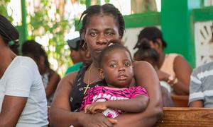 Mothers wait with their children to be vaccinated at a UNFPA-suppoted hospital in southern Haiti.
