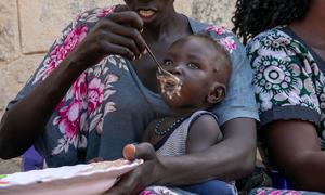 A women feeds her child at a nutrition site in South Sudan.