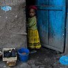 Une fille se tient devant sa maison dans la région du Tigré, en Éthiopie.