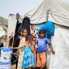 A displaced family receive relief items at a site in Lahaj governerate, Yemen.