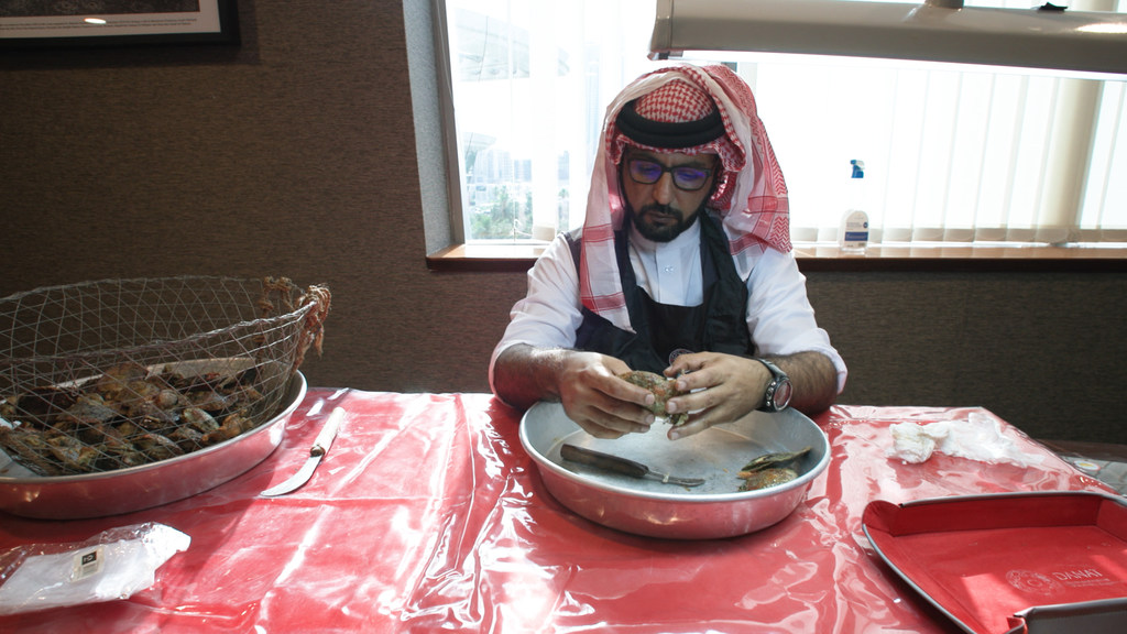 Bahraini diver, Mohamed Alslaise extracting pearls from oysters.